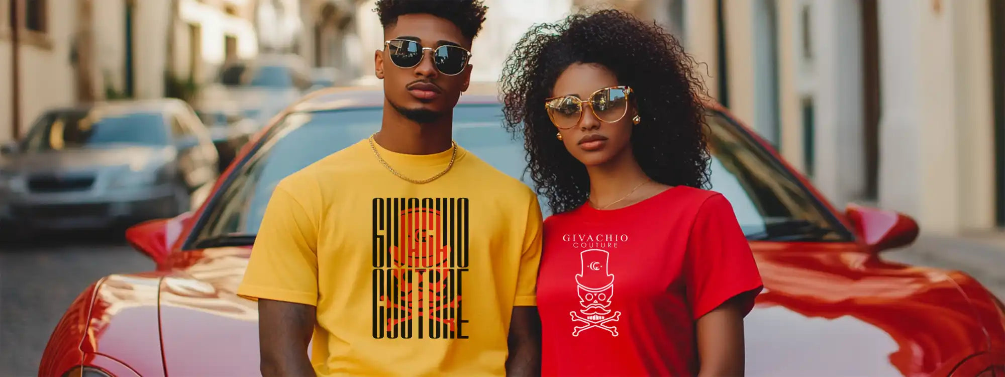 Two people in front of a red car.